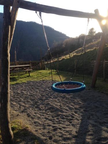 a swing in a playground with a mountain in the background at Auberge des isards in Aydius