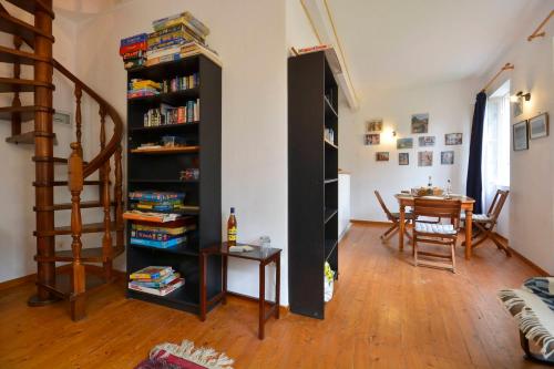 a room with a book shelf with books and a table at Iliokambida house in Corfu