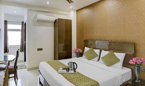una camera d'albergo con letto, tavolo e sedie di FabHotel 19 West a Nuova Delhi