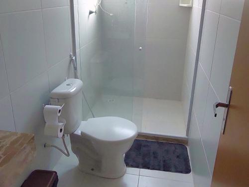 a bathroom with a toilet and a shower at Vilage Aconchegante - Imbassaí in Imbassai