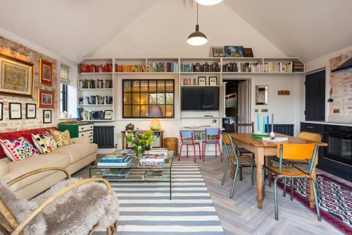 a living room with a couch and a table at The Outbuilding Appledore in Snargate