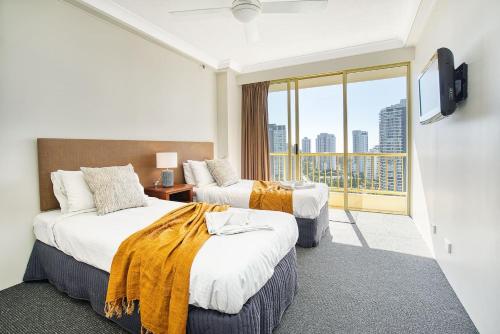 a hotel room with two beds and a balcony at Retro Main Beach Hidden Gem with Waterfront Views in Gold Coast