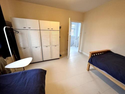 a bedroom with a bed and some lockers in it at 1 Bedroom flat, Close to All You Need! in Kenton