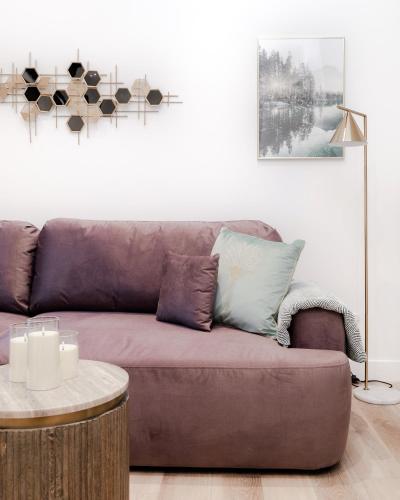a brown couch in a living room with a table at Stylish Apartments - Hyde Park in London