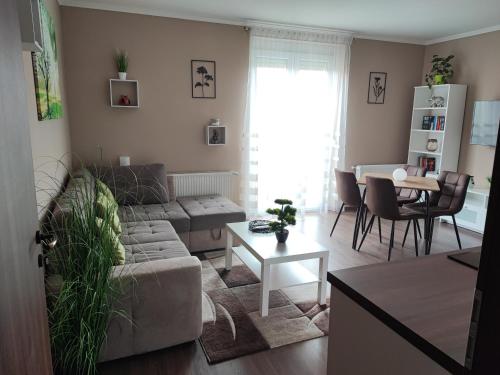 a living room with a couch and a table at Marianna Apartman Kaposvár in Kaposvár