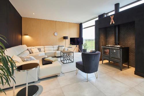 a living room with a couch and a fireplace at Host & Stay - Sleeper Cottage in Brompton