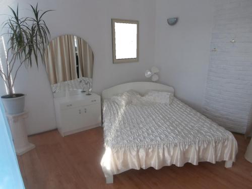 a white bedroom with a bed and a sink at Private Apartment For You in Tartu