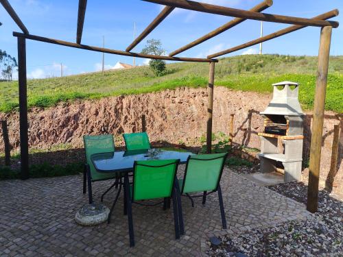 a patio with a table and chairs and a stove at Quinta da Eira Silves in Silves