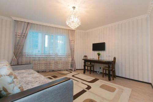 a living room with a couch and a table at 2 bedroom apartment on Sarayshyq street 5E in Astana