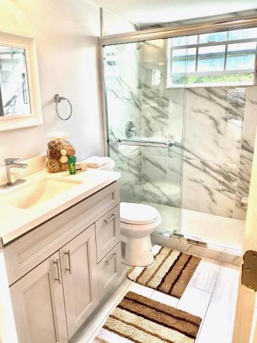 a bathroom with a shower and a toilet and a sink at Great Lovely Family Apartment close Disney in Kissimmee