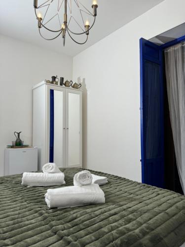 a bedroom with a large bed with towels on it at Castaños 4 in Alicante