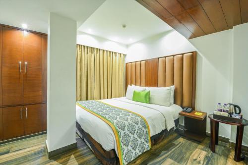 a hotel room with a bed and a cabinet at Flute Boutique by Hotel 91 in Jaipur