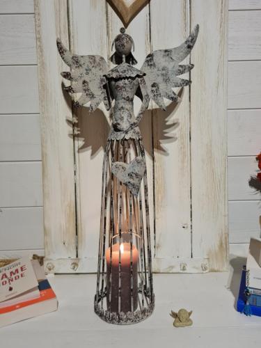 a wooden statue of an angel with a candle at La Flambée in Blond