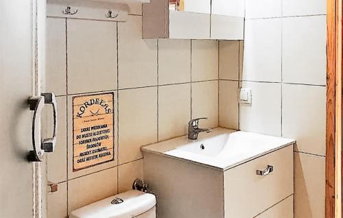 a small bathroom with a sink and a toilet at 1 Bedroom Stunning Home In Rewal in Rewal