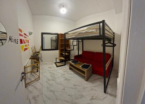 a room with a bunk bed and a red couch at Bed and breakfast chez l'habitant in Marseille