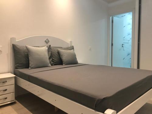 a bedroom with a large bed with a large mirror at PrG Apartments in Praia