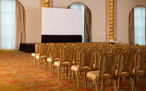 a row of chairs in a room with a screen at Badamdar Hotel and Residences in Baku