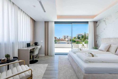 a bedroom with a large bed and a desk and a window at 797 HOLIDAY RENTALS - Lujosa y moderna villa en Puerto marina in Benalmadena Costa