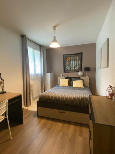 une chambre avec un lit et un bureau et une cuisine dans l'établissement Rez de jardin - JO 2024, à Plaisir