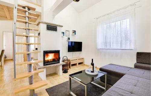 a living room with a couch and a fireplace at 3 Bedroom Cozy Home In Stari Brod in Stari Brod