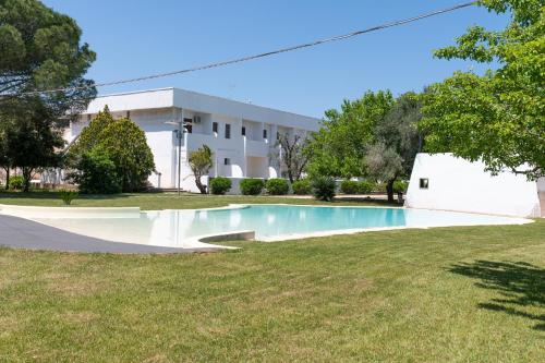 an empty swimming pool in front of a building at Relais Porta del Sud in Ostuni