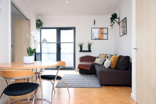a living room with a couch and a table at Centrally Located Spacious 2BR | CoHost Partners in Cardiff