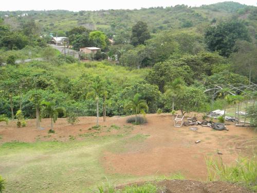 a field with a pile of dirt and trees at Centro Vacacional RECREASANA in Puerto López