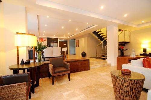 a living room with a couch and a table at The Villa at Temple - A Luxury Resort Hideaway in Port Douglas