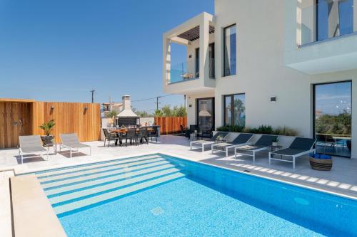 a house with a swimming pool and a patio at AKEA VILLAS in Tragaki