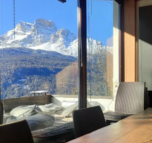 um quarto com uma grande janela com vista para a montanha em "Lo Chalet 450" vicino Cortina d'Ampezzo em Borca di Cadore