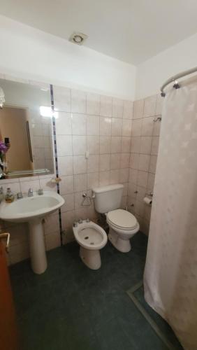 a bathroom with a sink and a toilet and a sink at Casiopea Apart in San Fernando del Valle de Catamarca