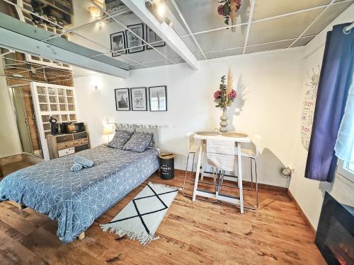 a bedroom with a bed and a table at Magic Studio - Disneyland Paris Shopping village 9 minutes in Chessy