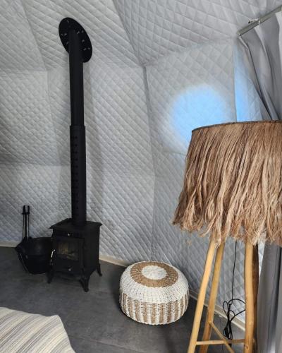 a room with a stove in a tent at River Glamping Kalopanayiotis in Kalopanayiotis