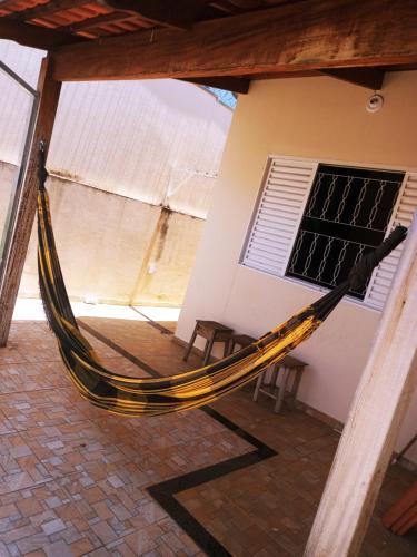 a hammock in front of a building at Casa da pri in São João Batista do Glória