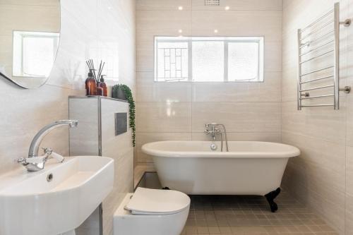 La salle de bains est pourvue d'une baignoire, de toilettes et d'un lavabo. dans l'établissement Tweede Boom, à Gordons Bay