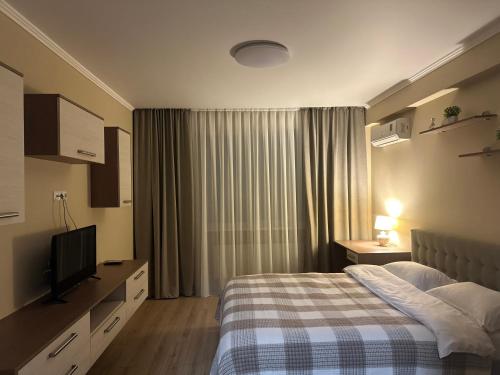 En eller flere senge i et værelse på Apartament Confortabil!
