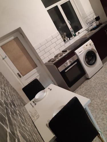 a kitchen with a stove and a microwave at Single Room in Oldham
