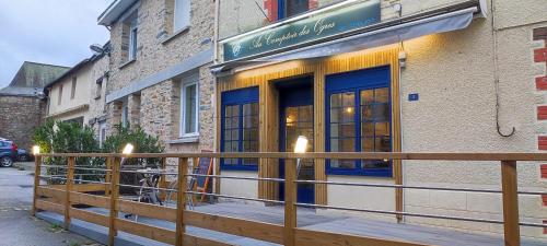 a building with a fence in front of a store at Chambre chez l'habitant "cactus" une, deux ou trois personnes in Derval