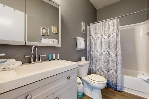 a bathroom with a sink and a toilet and a shower at Okaloosa Island Studio in Fort Walton Beach