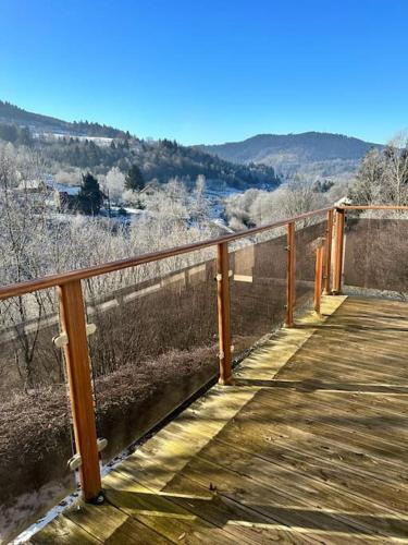 a wooden boardwalk with a view of a valley at Retour aux sources in Ventron