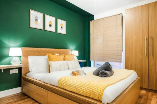 a bedroom with a bed with two stuffed animals on it at Emerald Retreat - City Centre - Free Parking, Fast WiFi and Smart TV by Yoko Property in Derby