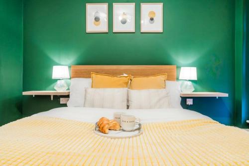 a bed with a plate of food on top of it at Emerald Retreat - City Centre - Free Parking, Fast WiFi and Smart TV by Yoko Property in Derby