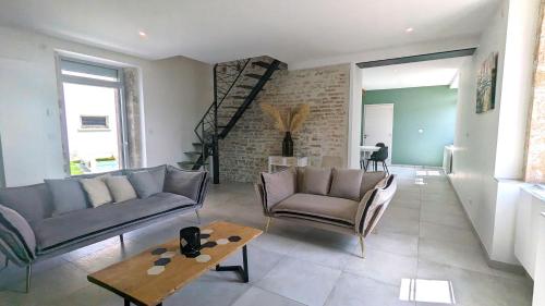 a living room with two couches and a coffee table at La Maison de Caro in Gevrey-Chambertin