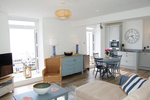 a living room with a couch and a table at Driftwood Designer Apartment in Tywyn