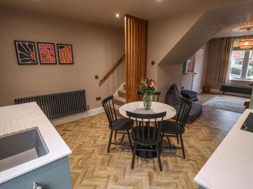 a kitchen and dining room with a table and chairs at 17 Union Road House in Lincoln