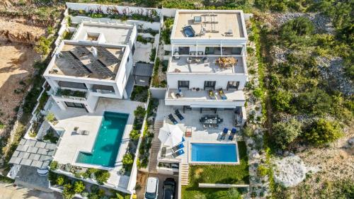 an aerial view of a house with a swimming pool at Villa Tyra in Ražanj