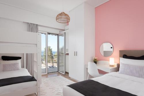 a bedroom with two beds and a desk and a mirror at Glyfada Cozy Living in Athens
