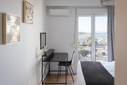 a bedroom with a desk and a bed and a window at Glyfada Cozy Living in Athens