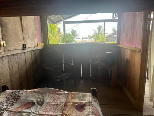 a room with a bed in a room with a window at Iguana Azul Pacific Paradise in Buenaventura