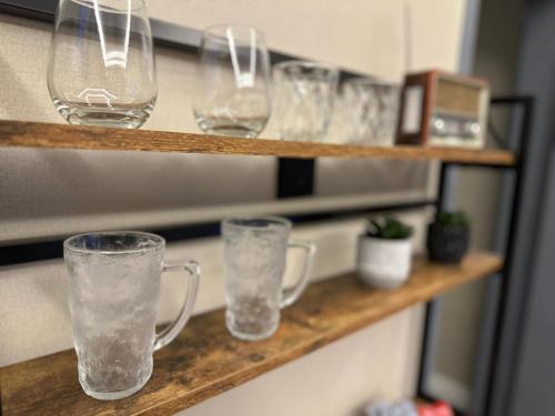 a group of glasses sitting on a shelf at Riyadh Cozy Stylish One-Bedroom Apartment in Riyadh